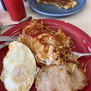 My breakfast of pork chop, over medium eggs, hash browns and a pancake.