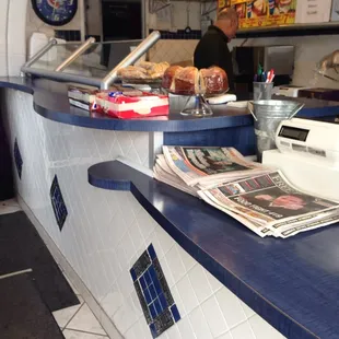 a counter with a newspaper on it