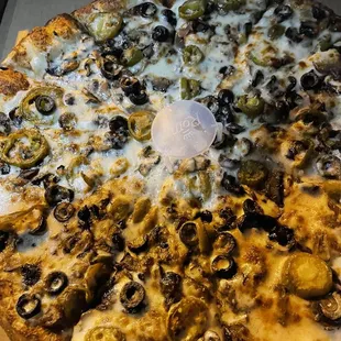 a pizza with olives and cheese