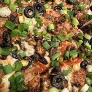 Combination pizza with NO bell peppers and green onions instead of yellow ones.