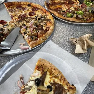 a table full of pizzas