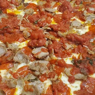 Old fashioned pizza with sausage and pepperoni added