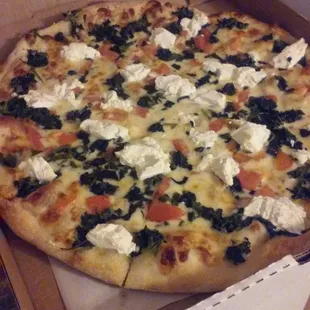 White pie with spinach, tomatoes, ricotta, and mozz.