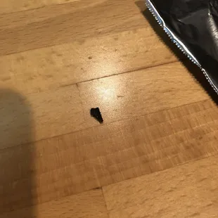 a piece of pizza left on the floor