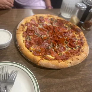 a pepperoni pizza on a table