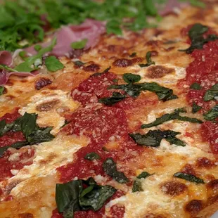 Half grandma pizza and half prosciutto/arugula pizza