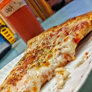 a slice of pizza on a plate