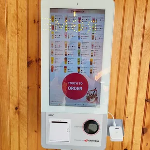 a digital ordering machine in a wood paneled room