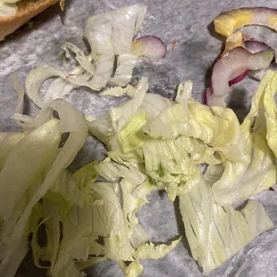 a sandwich with lettuce and onions