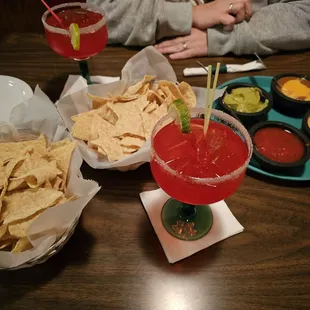 4 dip appetizer and a couple strawberry margaritas