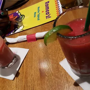 two glasses of juice with strawberries and lime