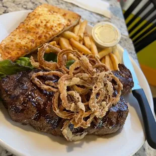 NY Strip Steak 
16-ounce hand cut steak served with fries topped with haystack onions