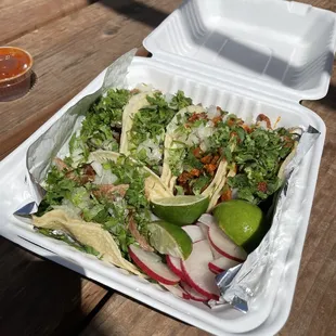 a salad in a styrofoam container
