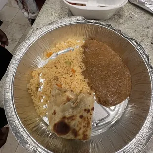 Kids chicken quesadillas. Comes with rice and beans. Never seen a quesadilla that looked like this ever.