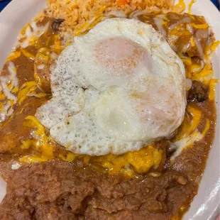 (Beef Fajita?) Enchiladas with fried eggs on top