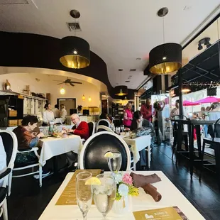 a busy restaurant with people sitting at tables