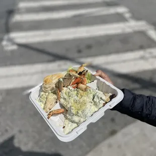 a person holding a tray of food