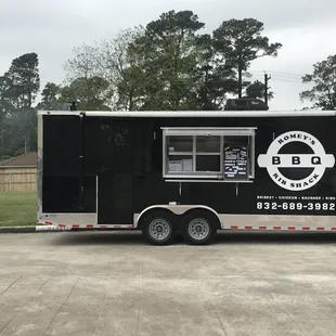 a bbq truck parked in a parking lot