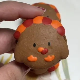 a hand holding a decorated cookie