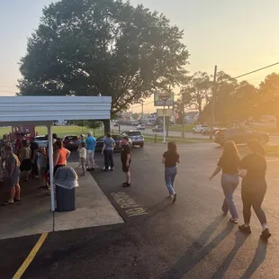 a group of people walking in a parking lot