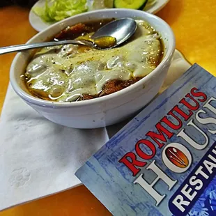 a bowl of soup and a book
