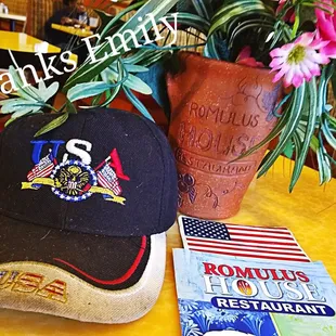 a hat and a book on a table