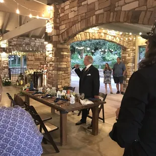 String lights, farmhouse tables and chairs, charger plates and silverware all from Romy's!