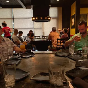 a group of people sitting at a restaurant table