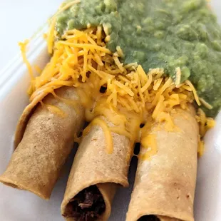 Rolled tacos with cheese and guacamole. Aka taquitos.