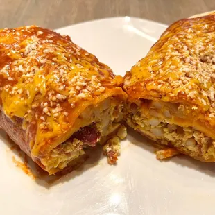 Section view. Bacon Breakfast Burrito (ordered a wet burrito for $3 extra). Comes with bacon, eggs, cheese, and potatoes.