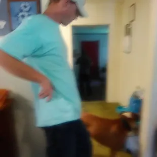 a blurry image of a man and his dog