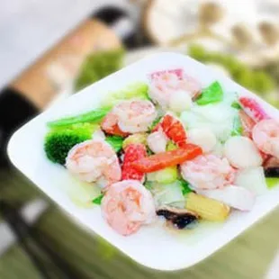 a bowl of shrimp and broccoli