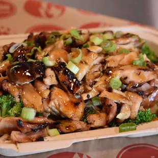 Nearly a pound of fresh locally sourced chicken over a bed of steamed veggies.