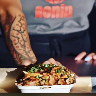  person holding a container of food