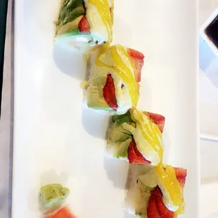 a close up of a sushi on a white plate