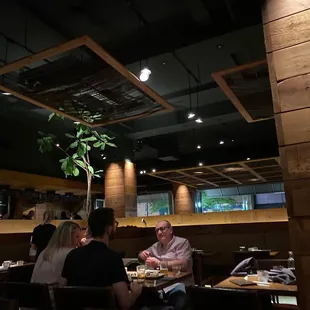 a group of people eating at a restaurant