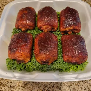 a tray of bacon wrapped in lettuce