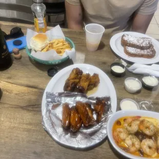 Shrimp and sausage cheese grits, hot and honey lemon pepper wings, French roast, seasoned fries