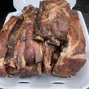 a pork roast in a styrofoam container