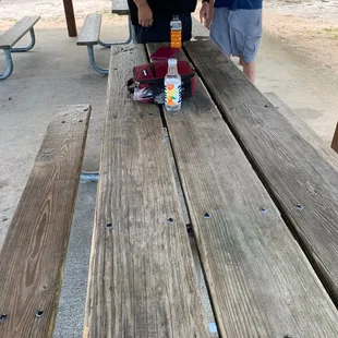 Picnic table in pavilion by tennis courts.