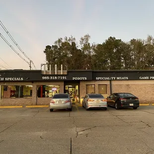 two cars parked in front of the store