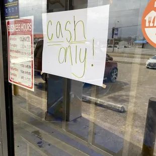 a cash only sign in the window