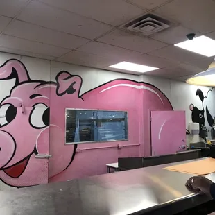 a pink pig painted on the wall