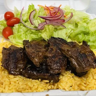 Steak tips over rice.