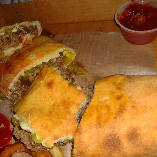 Steak and cheese calzone with pickles