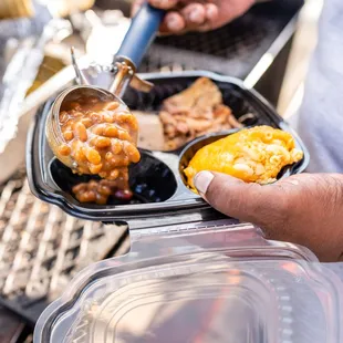 a person holding a container of food