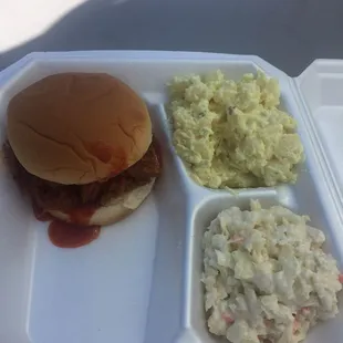 Pulled Pork Sandwich with slaw on the side and an order of potato salad