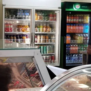 a man standing in front of a refrigerated refrigerator