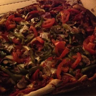 Pepperoni, mushroom, sausage, peppers, tomatoes and onion on thin crust.