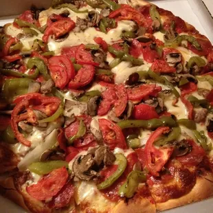 "Italian style deluxe": pepperoni, green peppers, tomatoes, sausage, onion, mushroom
